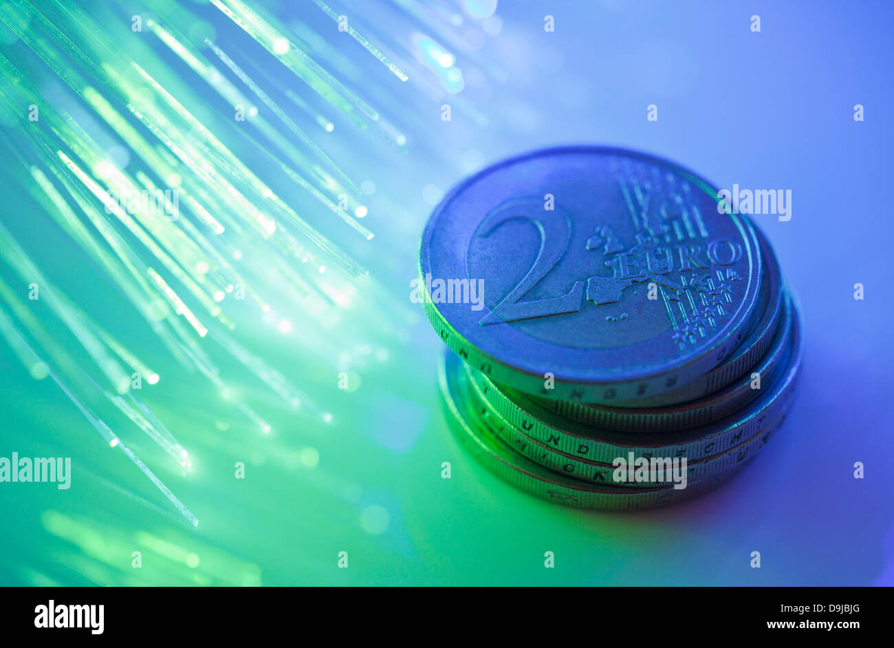Euro coins on fiber optics background Stock Photo