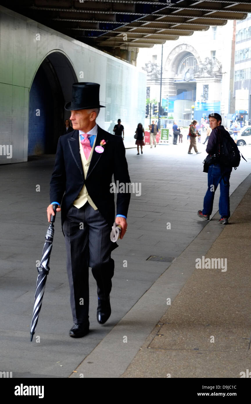 Race- goers on their way to Royal Ascot wait for trains at Waterloo Station Stock Photo