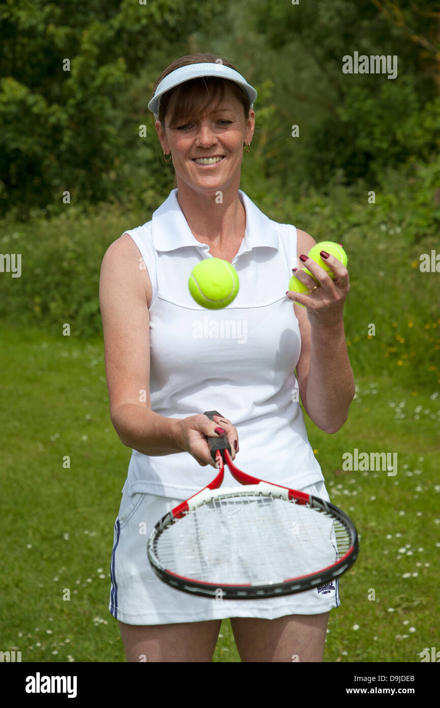 Female tennis player with racquet and balls. Stock Photo