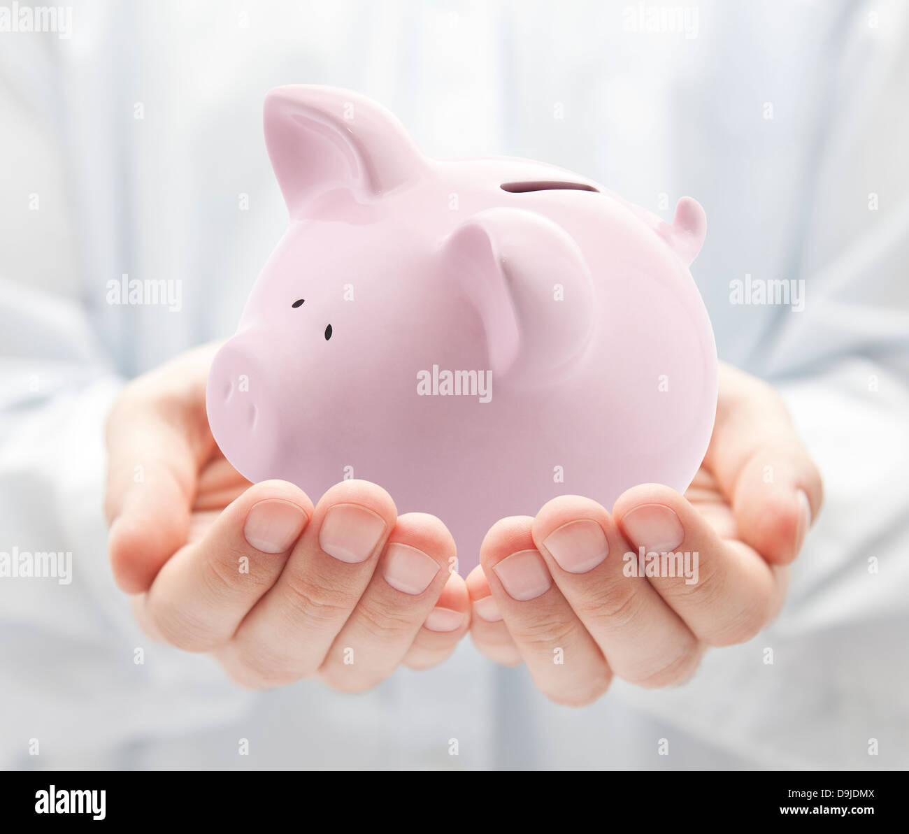 Man holding big pink piggy bank Stock Photo - Alamy