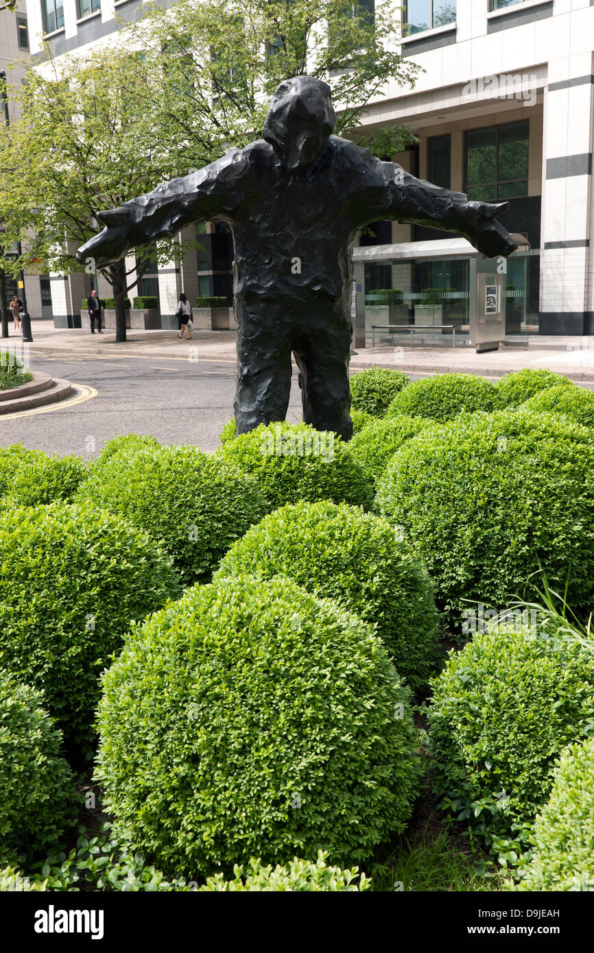 Bronze figure entitled Man with Arms Open, by sculptor Giles Penny at Canary Wharf Stock Photo