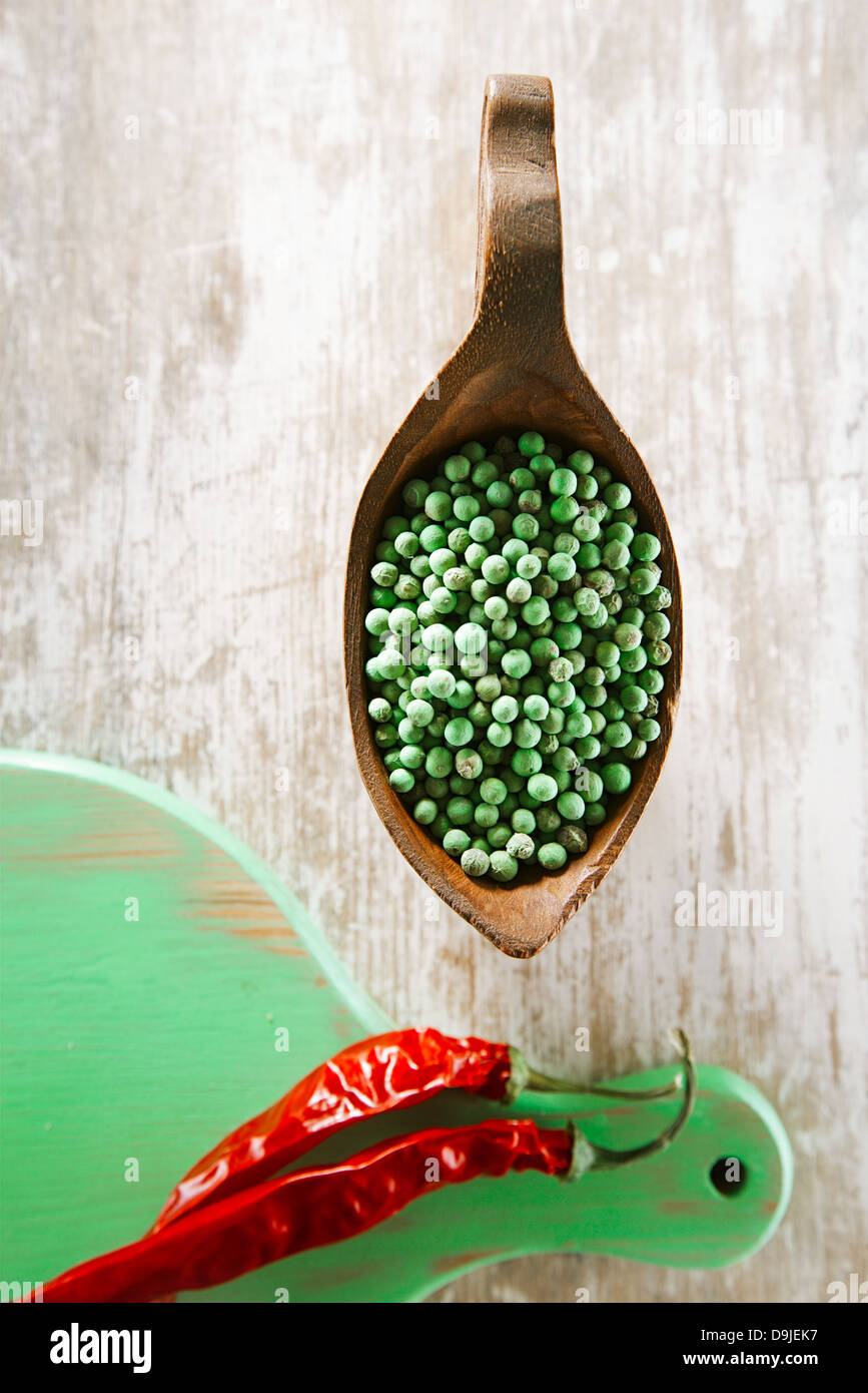 Green Peppercorn In Bowl And Red Chillies On Green Wooden Board Shallow Dof Stock Photo Alamy