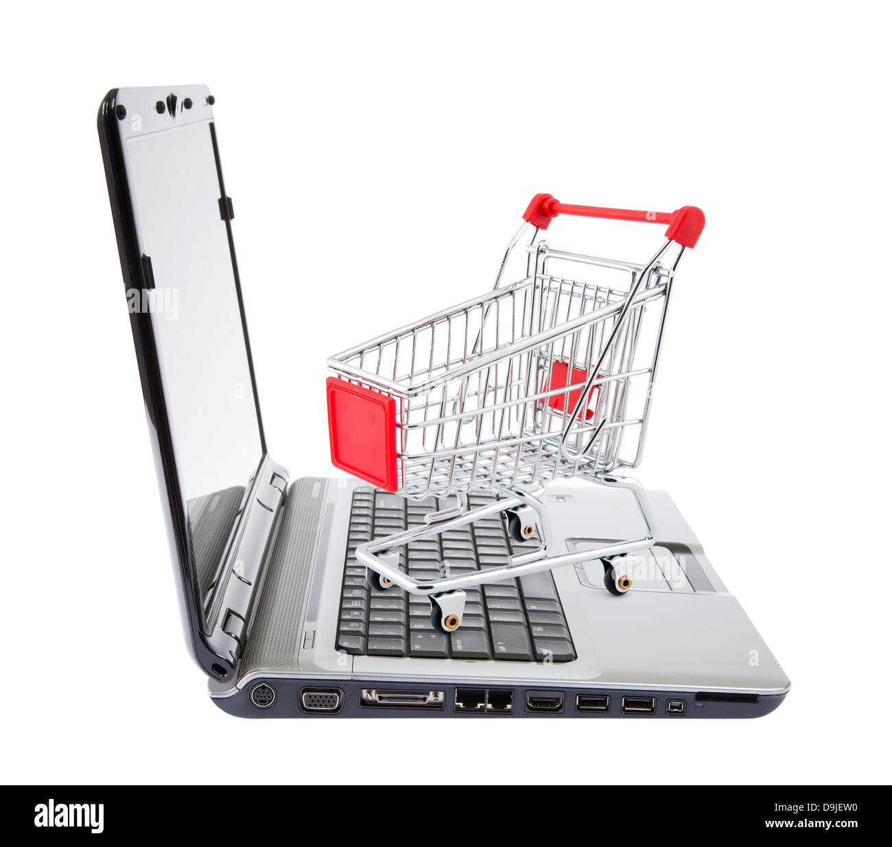 Online shopping. Shopping cart with laptop on white. Stock Photo