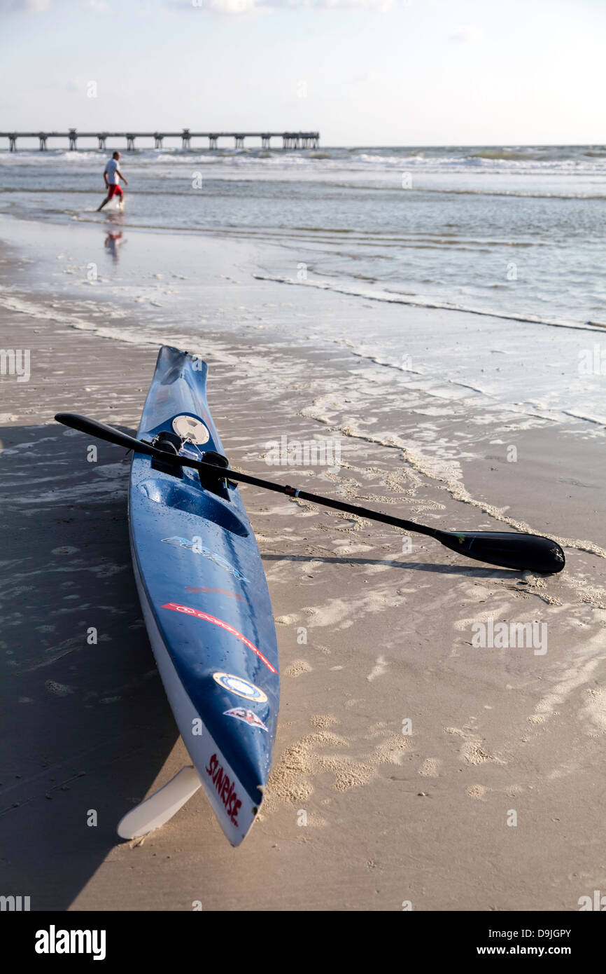 Blue ocean kayak sitting on Jacksonville Beach at the surf line. A