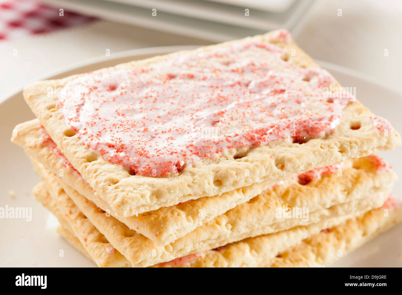Hot Strawberry Toaster Pastry with frosting and sprinkles Stock Photo