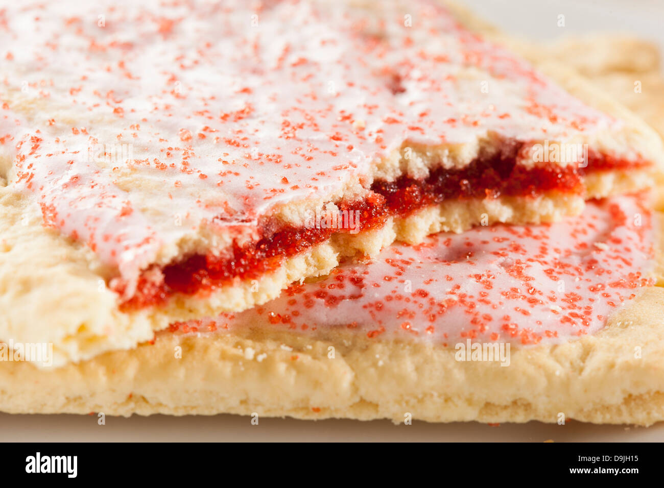 Hot Strawberry Toaster Pastry with frosting and sprinkles Stock Photo