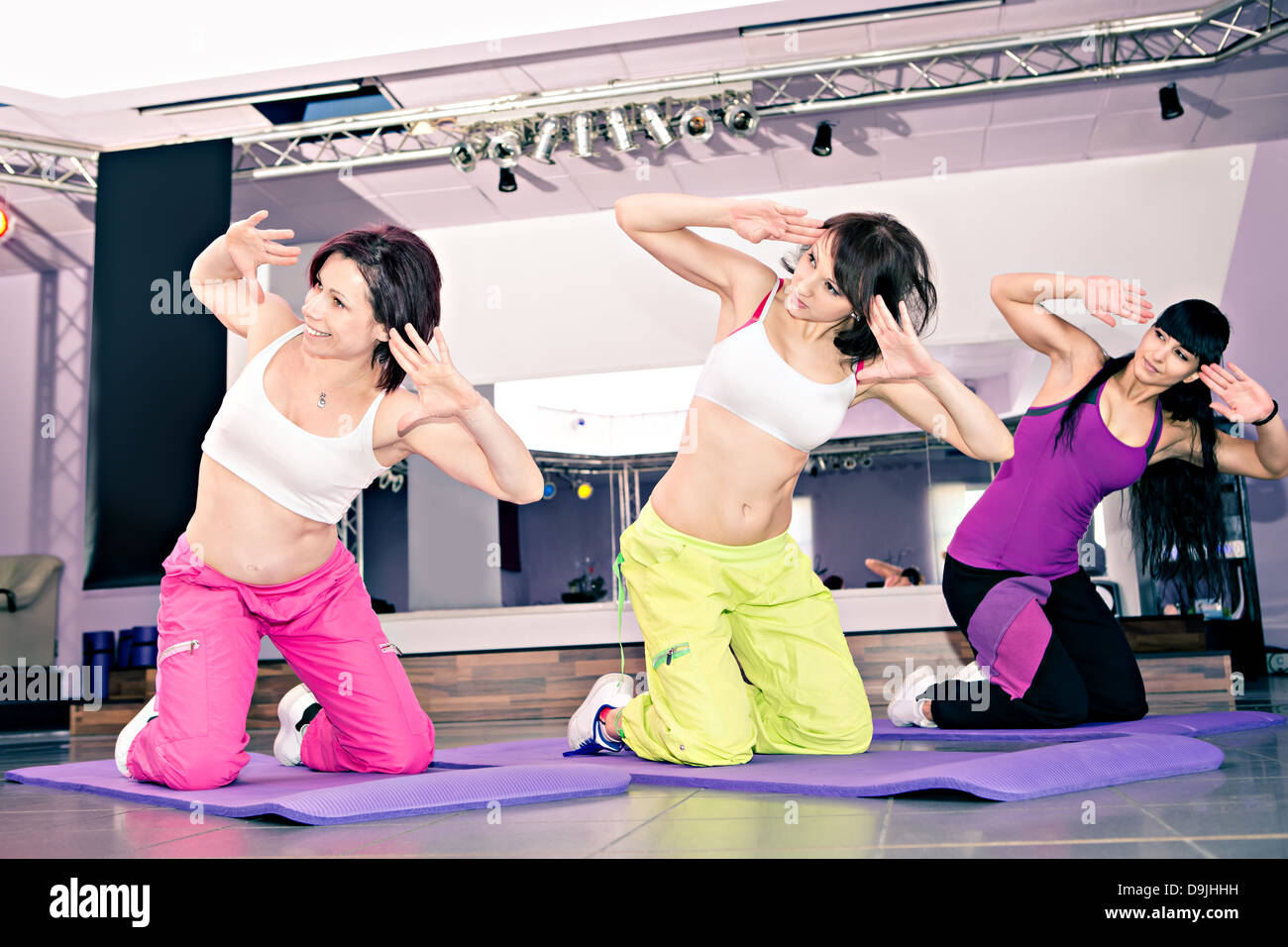 young women in sport dress at an aerobic and zumba exercise Stock Photo