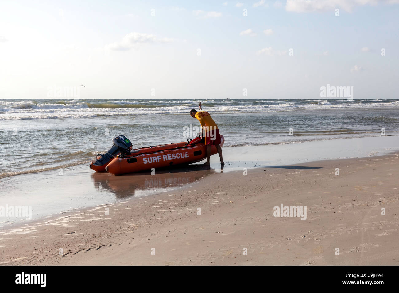 Surf Rescue volunteer preparing equipment and inflatable for the 4th