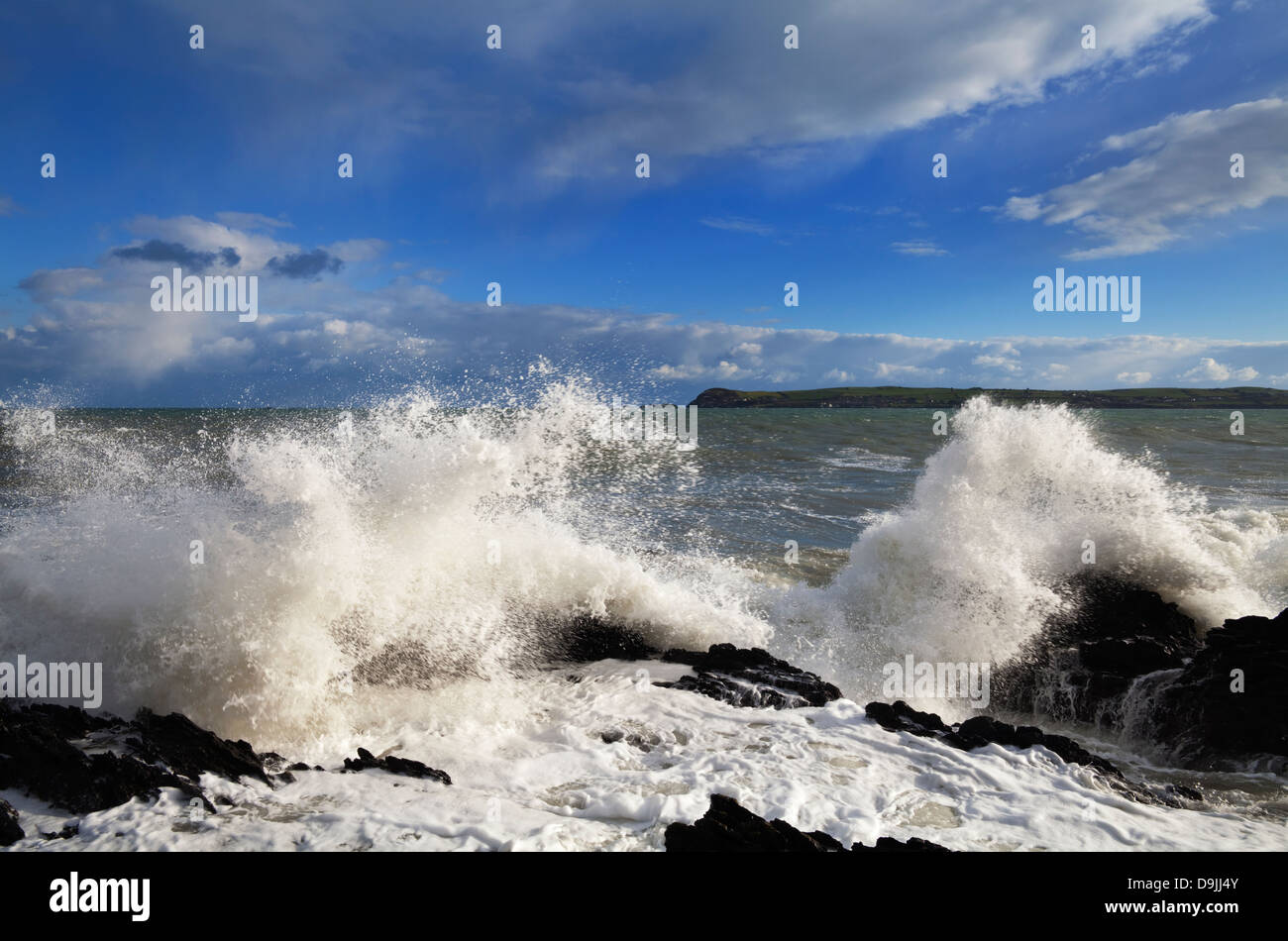 Waves and rocks near Ballinacourty Lighthouse at the entrance to Dungarvan Bay, County Waterford, Ireland Stock Photo
