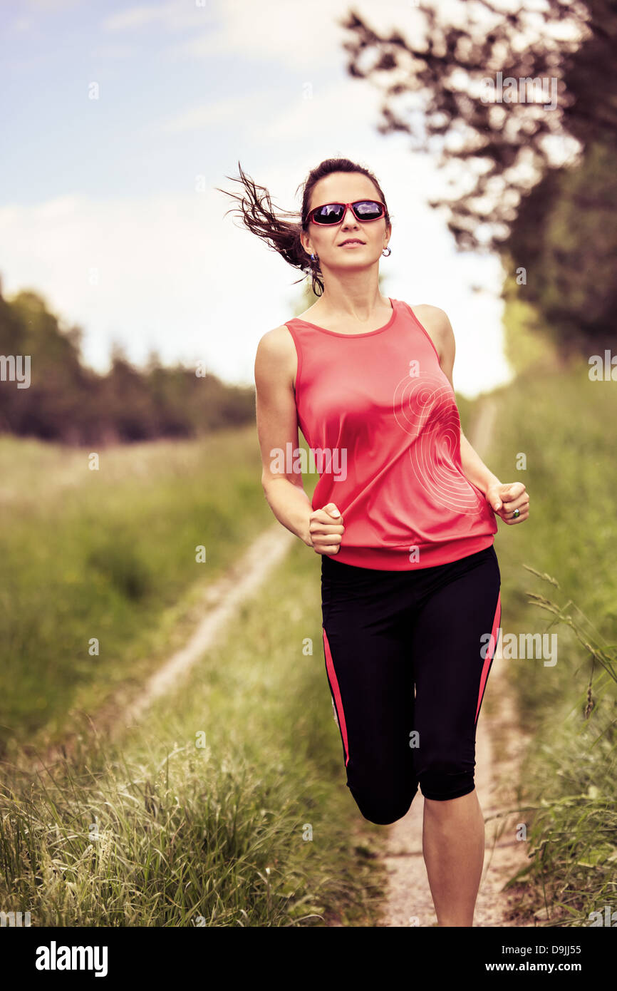 young woman jogging in front of rural landscape Stock Photo Alamy