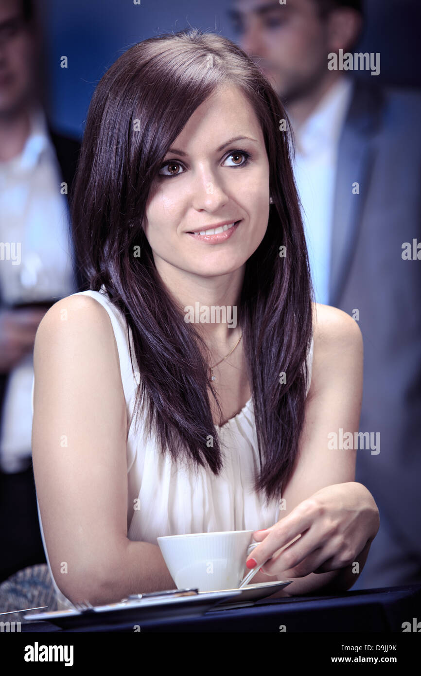 a young woman at table in a restaurant Stock Photo