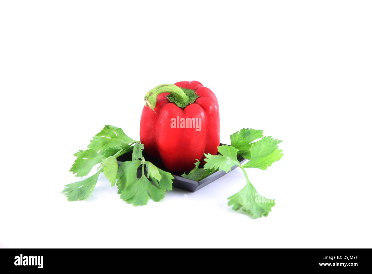 Red Sweet pepper in the dish on white background and Sweet pepper are high nutritional value. Stock Photo