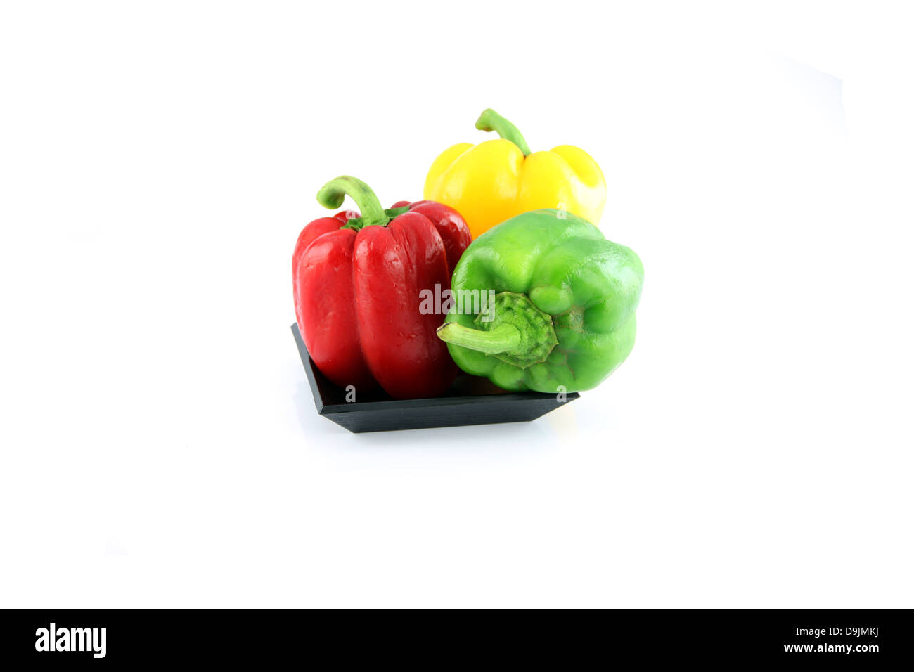 Three color of Bell pepper in a black dish on the white background. Stock Photo