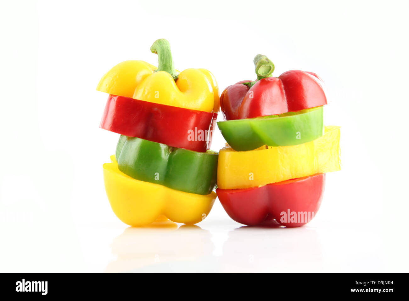 Slice the Three color of bell pepper in Arranged vertically on white