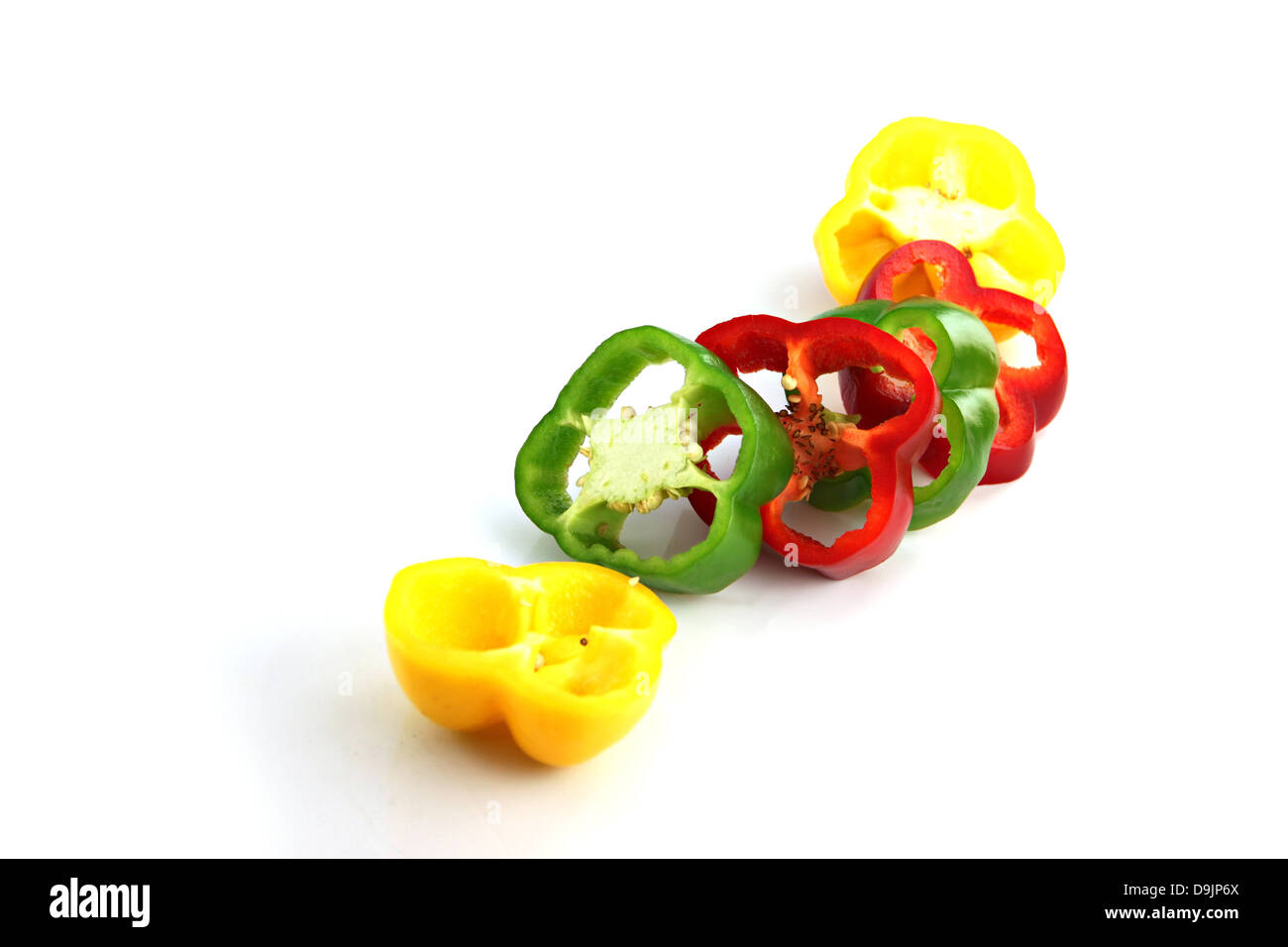Slice the Three color of bell pepper on the white background. Stock Photo