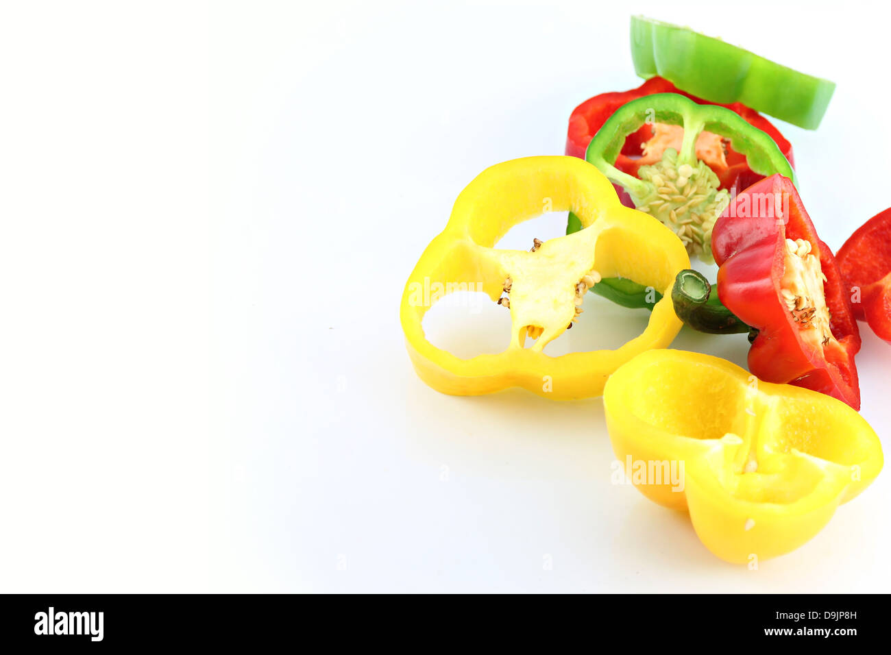 Slice the Three color of bell pepper on the white background. Stock Photo