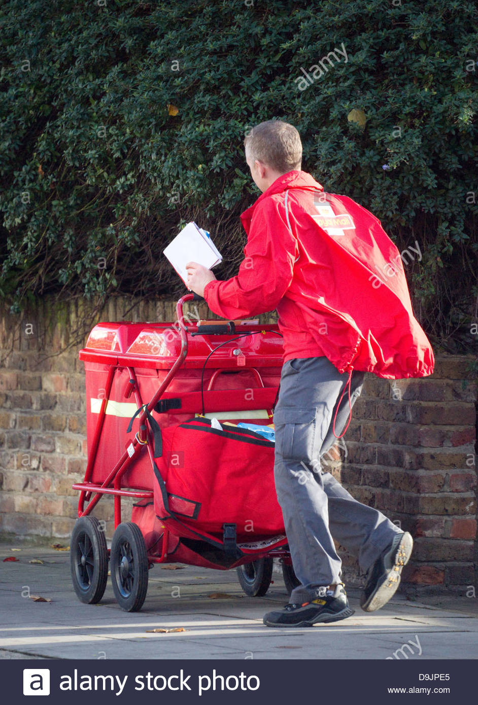 Postman Delivering Mail Stock Photos & Postman Delivering Mail Stock