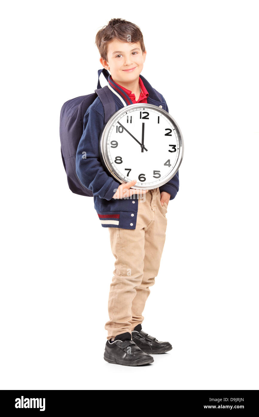 Full length portrait of a school boy with backpack holding a wall clock ...