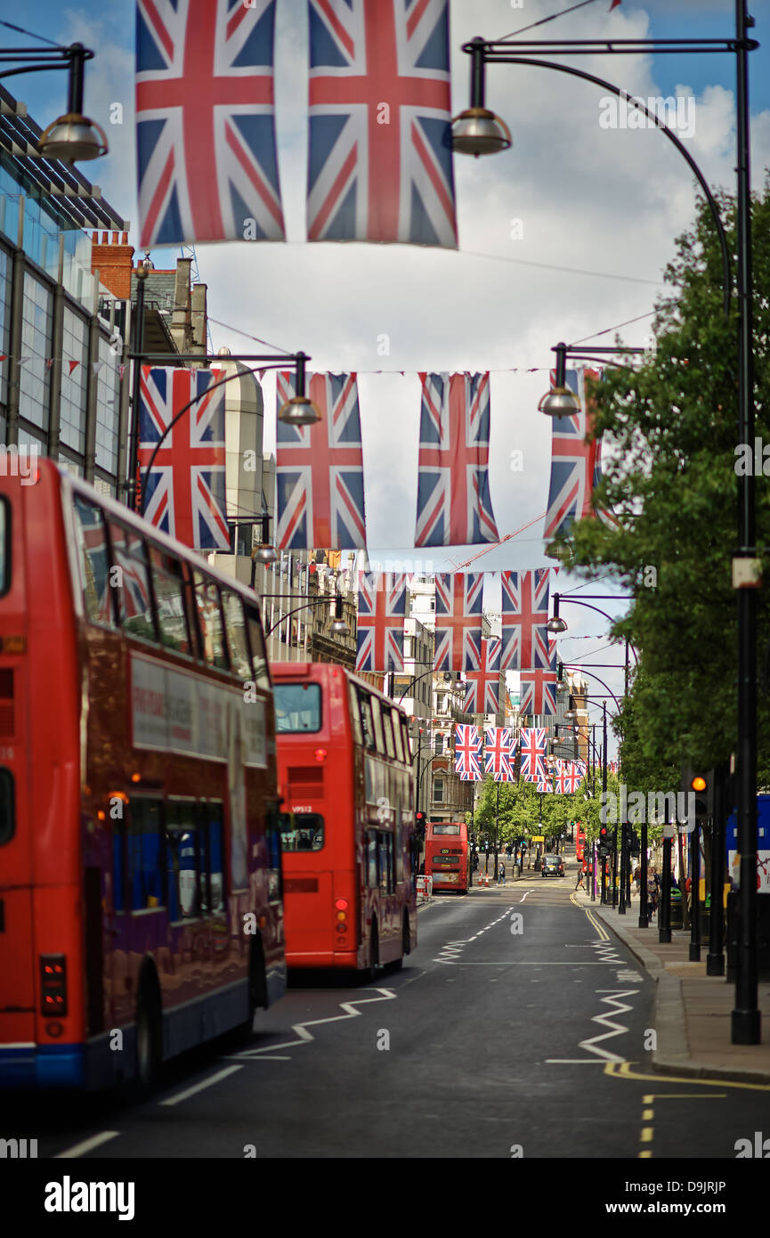 red buss in Oxford St with flags Stock Photo
