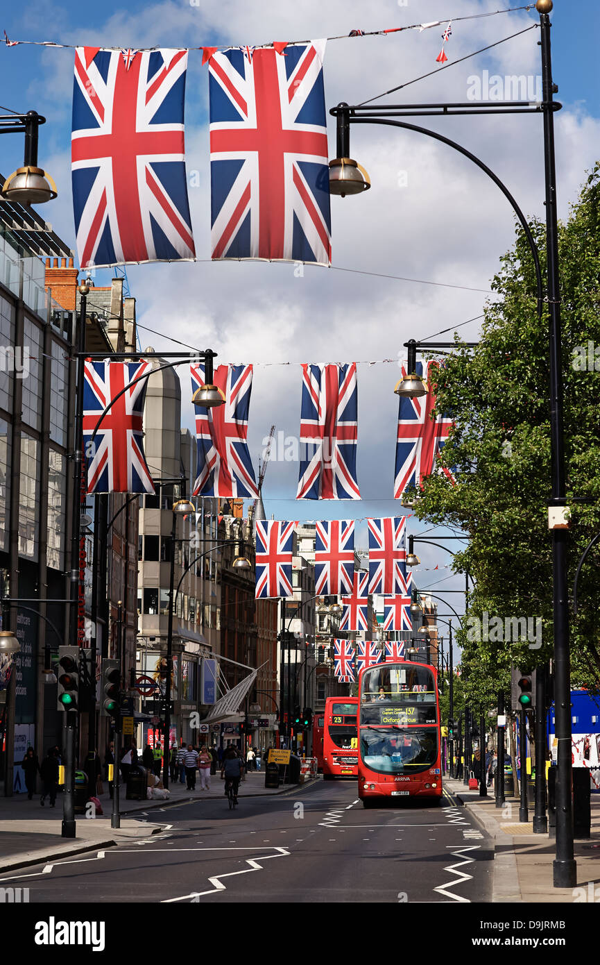 London Bus in Oxford Street with flags flying Stock Photo Alamy