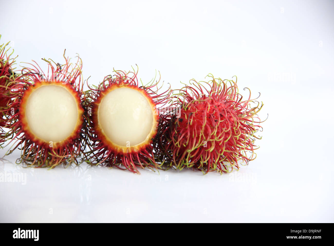 Rambutan Fruit is Peeled off on white Background. Stock Photo
