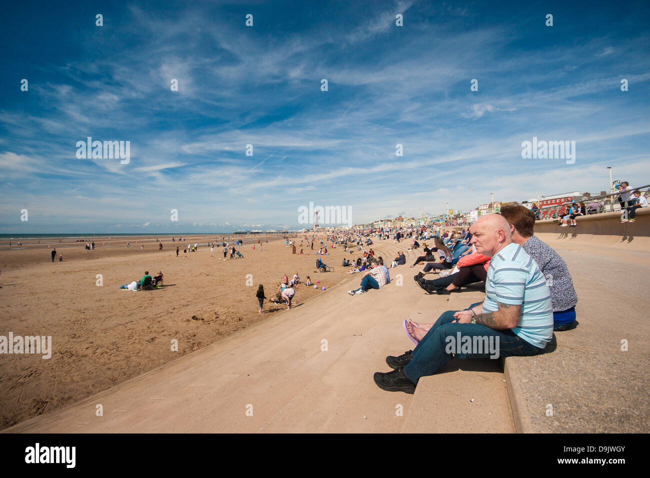 Poeple enjoying the sunshine on Blackpool beach Stock Photo