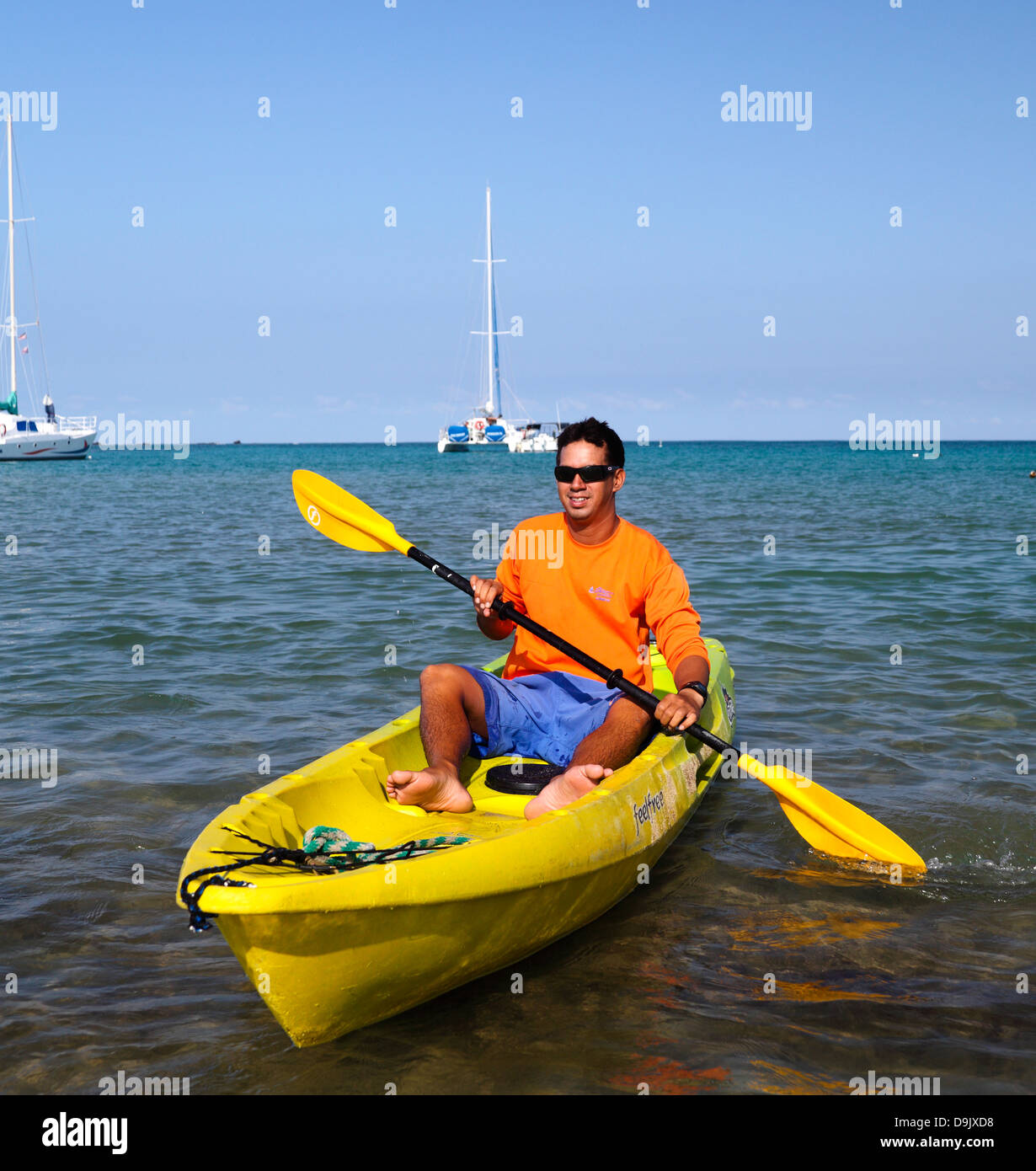 Ocean Sports team member kayaks in Anaehoomalu Bay on the Big Island of Hawaii Stock Photo