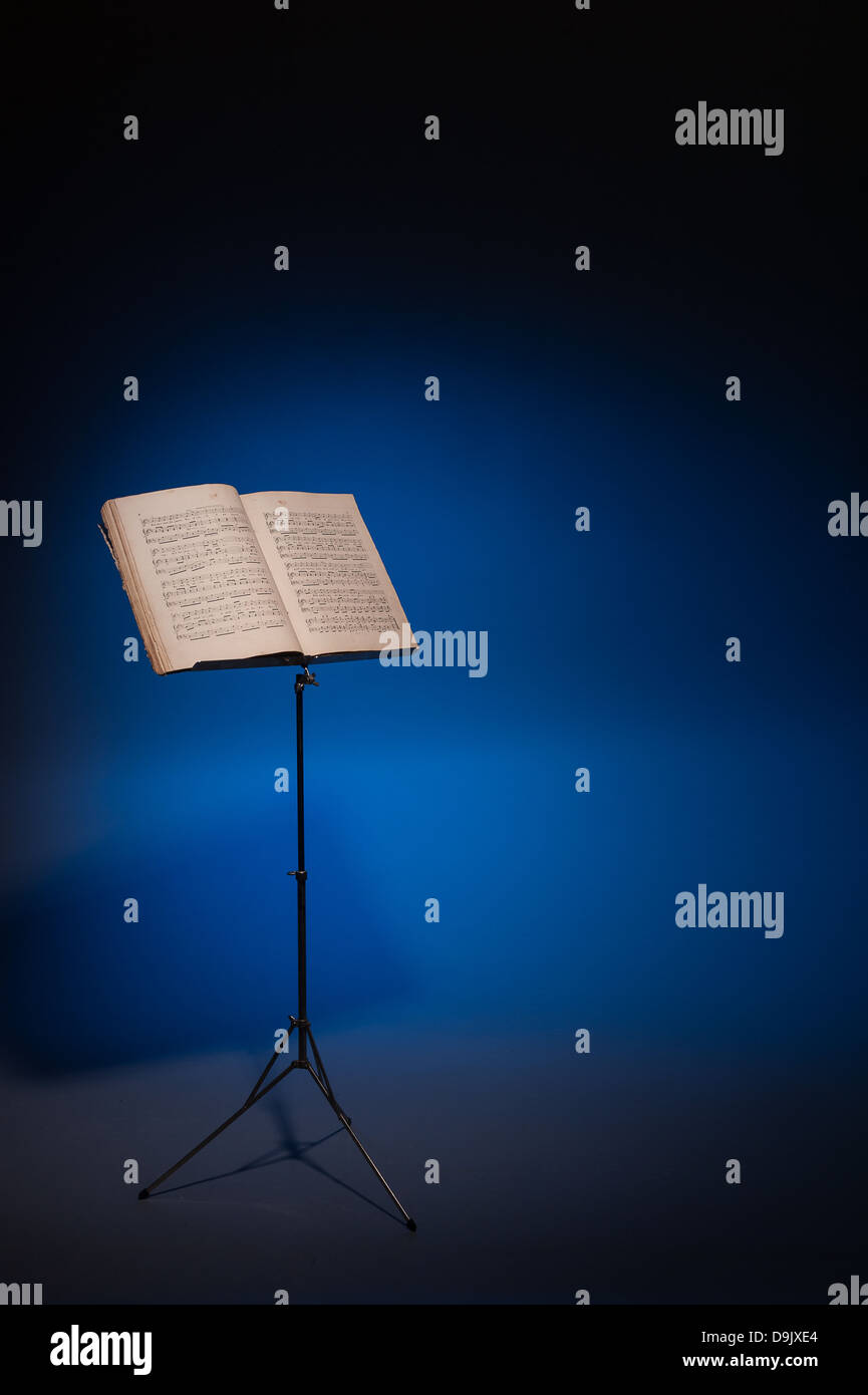 Vintage music on stand on atmospheric blue background Stock Photo