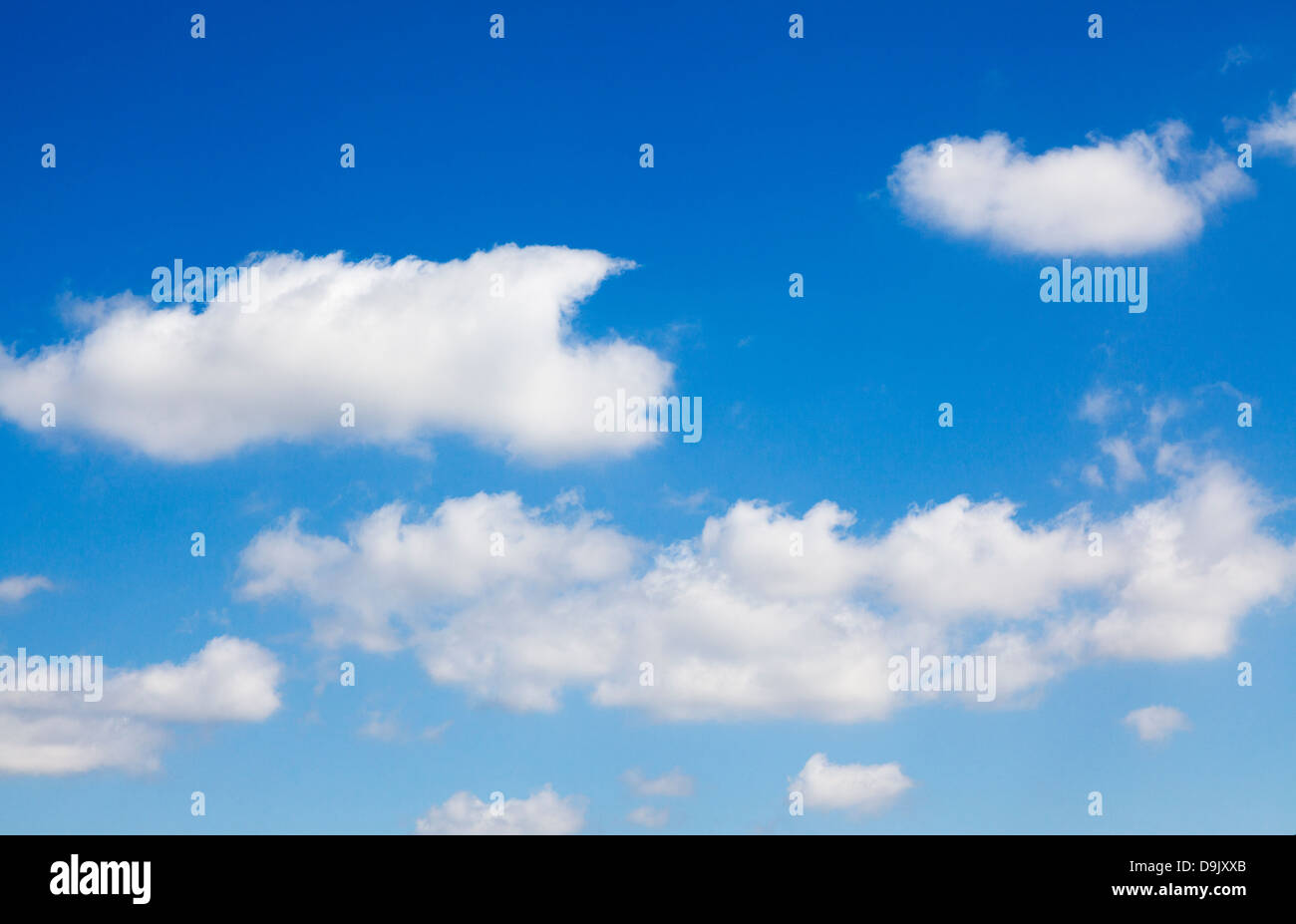 White fluffy clouds in a blue sky Stock Photo