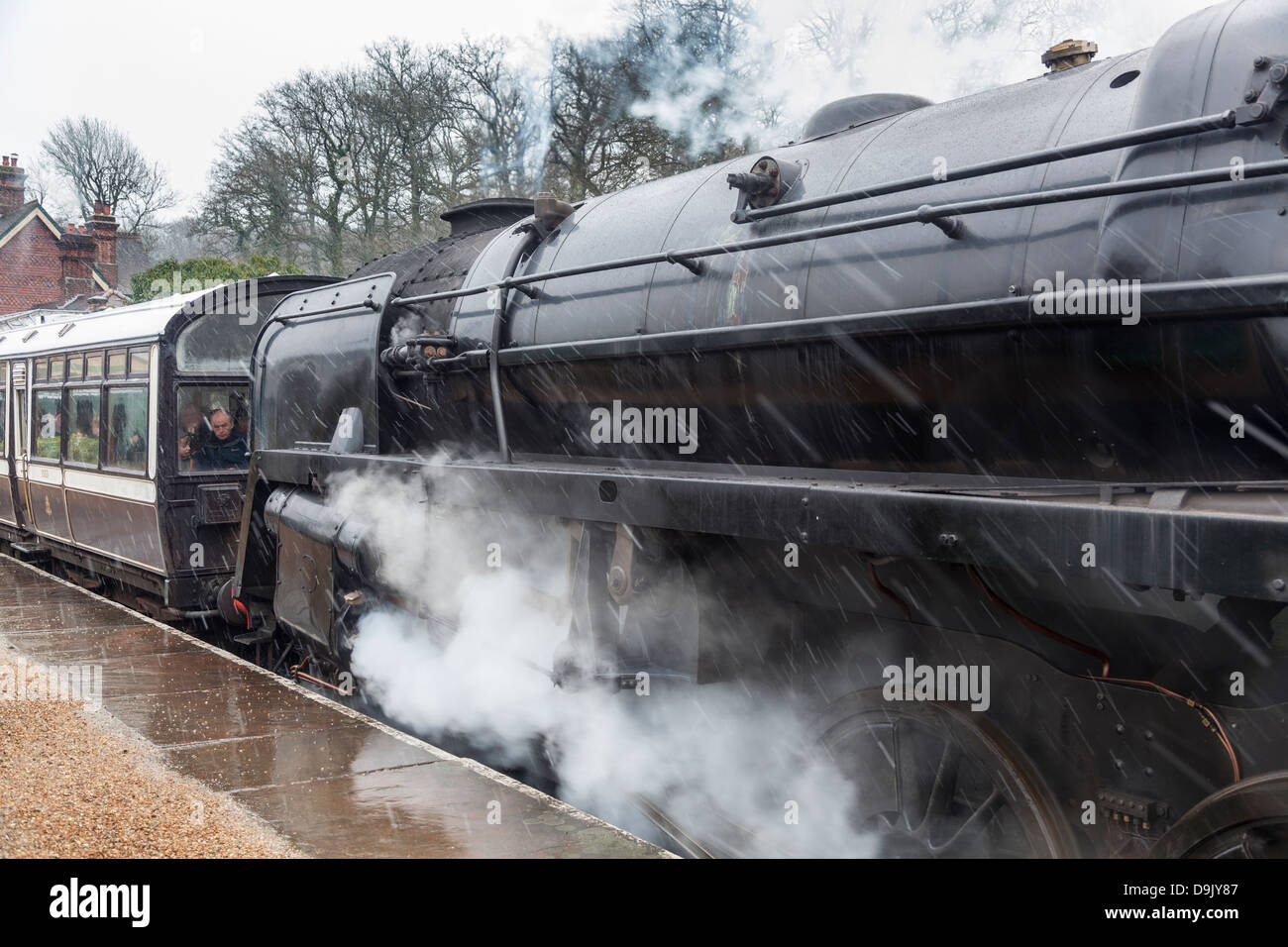 railway engine at Bluebell Railway, East Grinstead, West Sussex, UK in bad weather with clouds