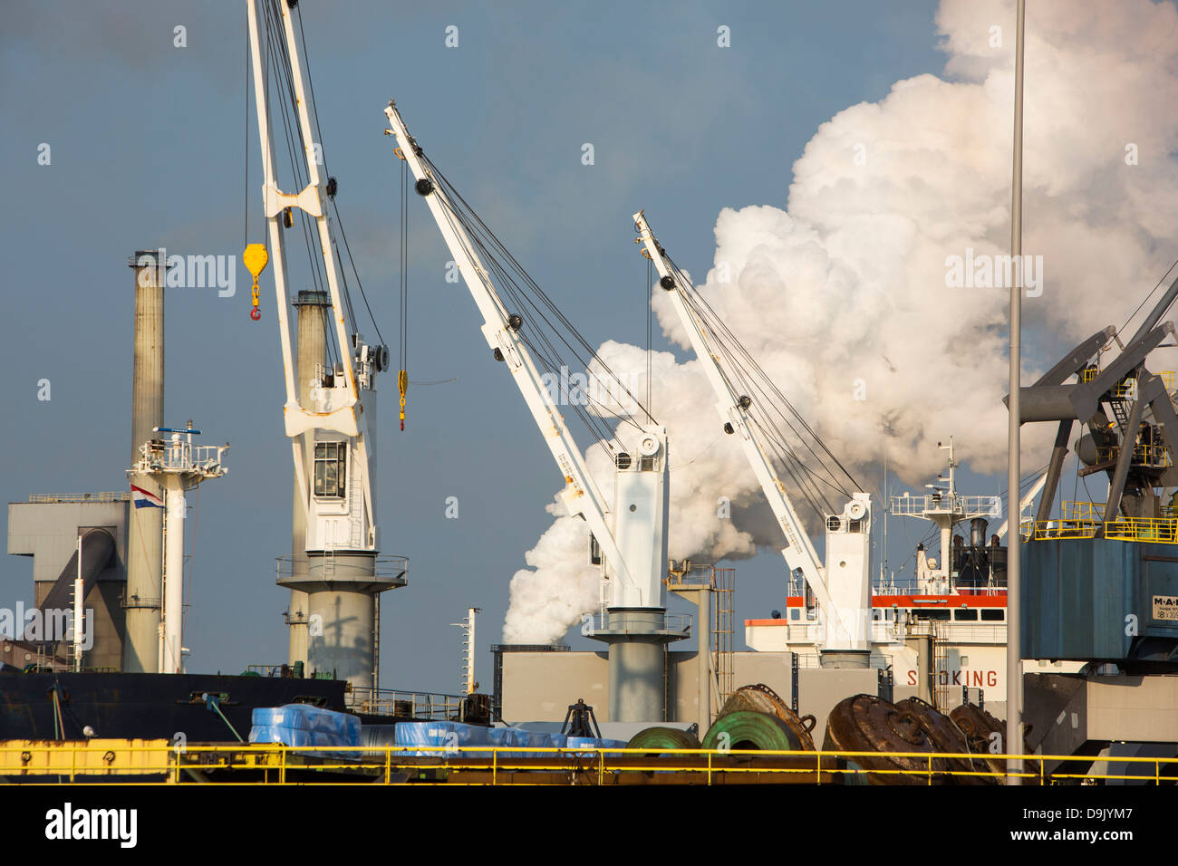 Emissions from the Ijmuiden, Tata steel works, Netherlands at sunset. Stock Photo