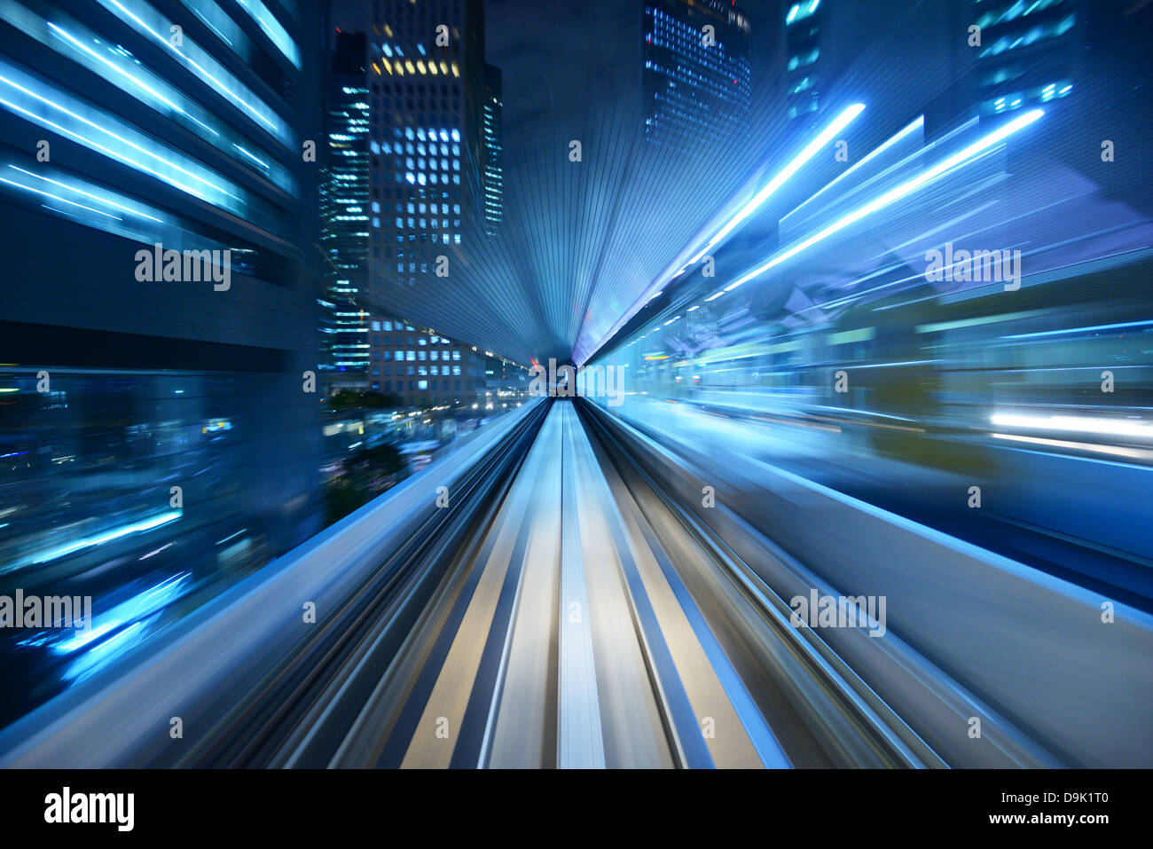 Motion blur of a city and tunnel from inside a moving monorail in Tokyo. Stock Photo