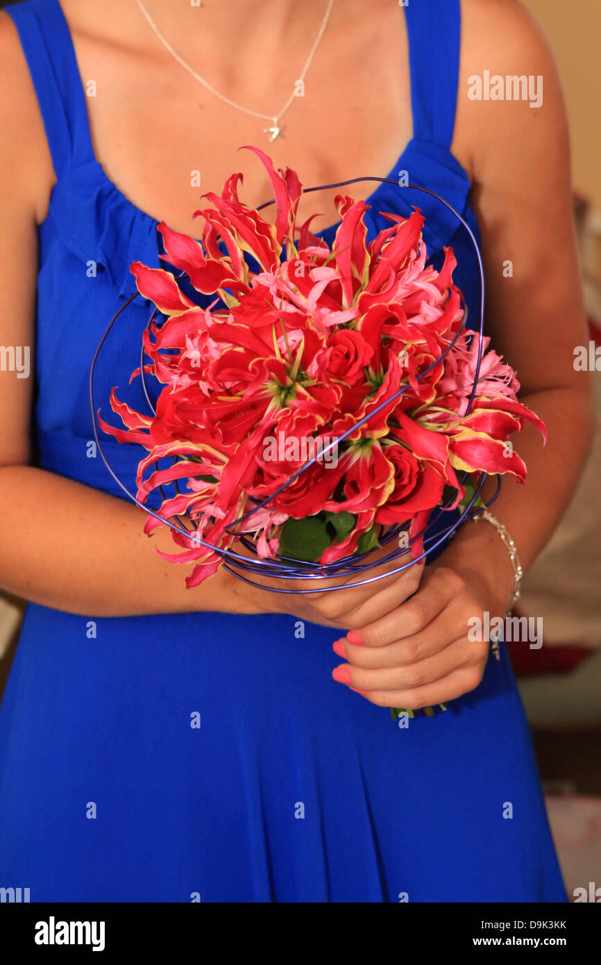 blue dress girl woman female wedding bridesmaid matron maid honor pink flowers bouquet necklace Stock Photo
