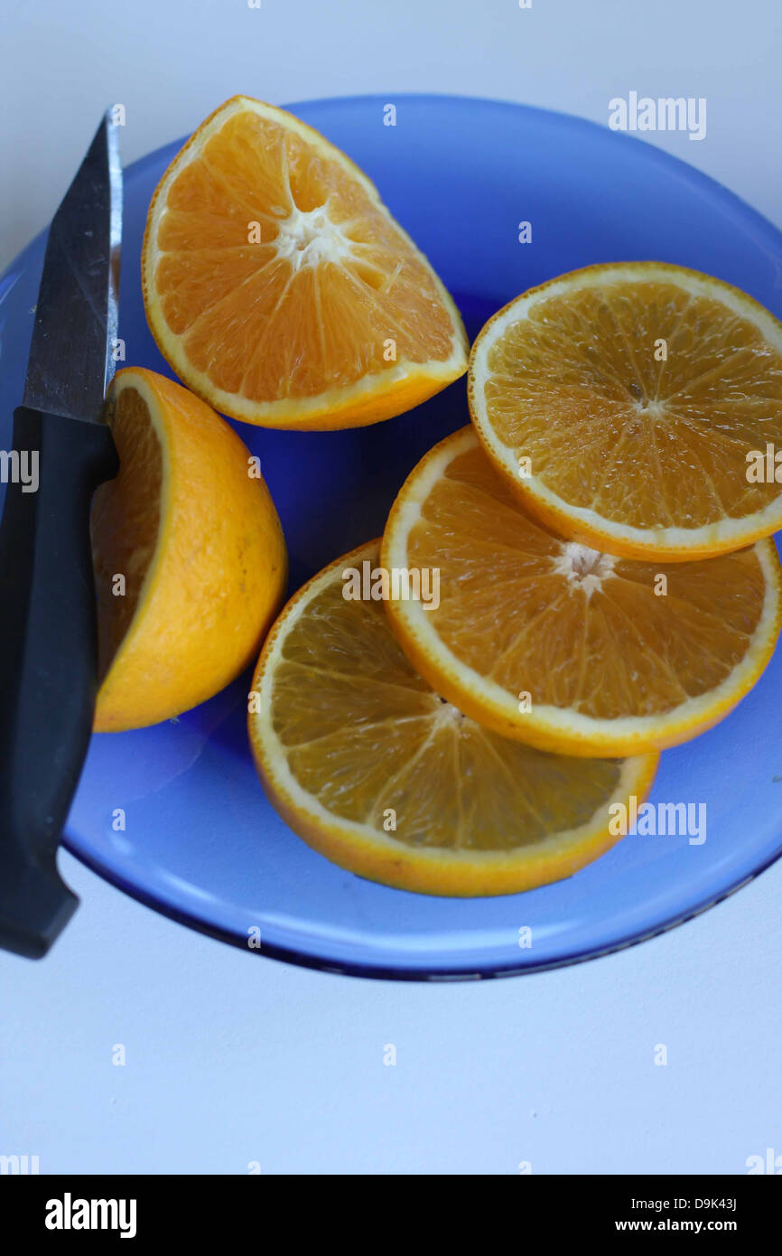 fruit orange oranges slice sliced slices knife blue plate pulp juice eat food Stock Photo
