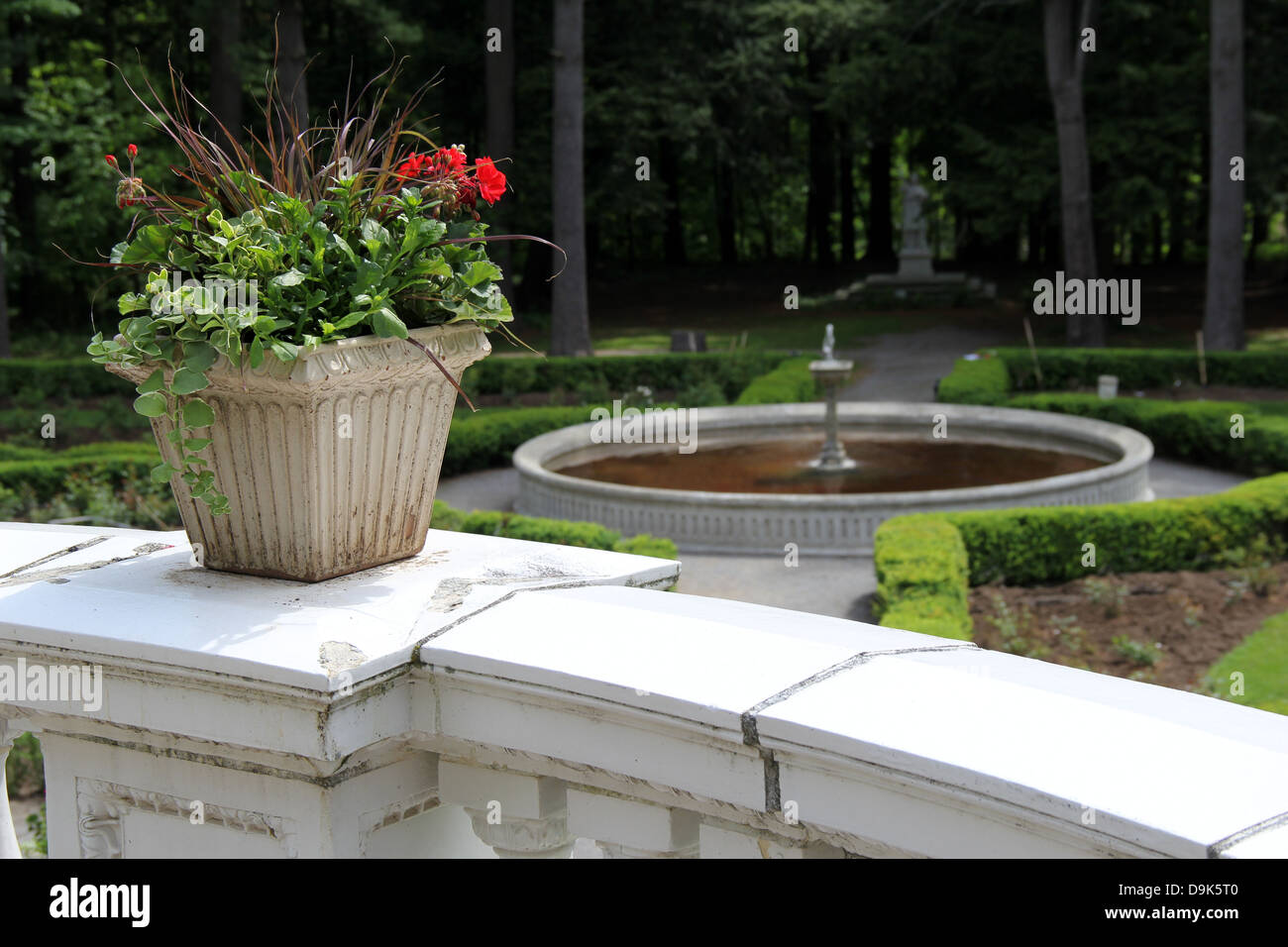 Pretty stone planter with variety of flowers on marble railing that ...