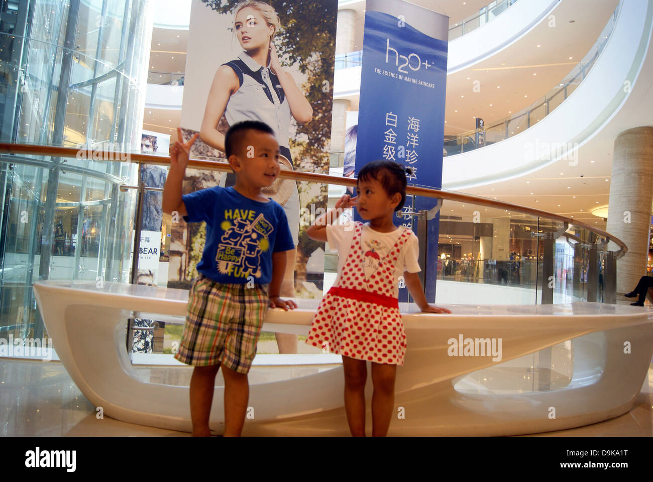 A man and a woman, two children, stand together, in shenzhen shopping mall in China. Stock Photo