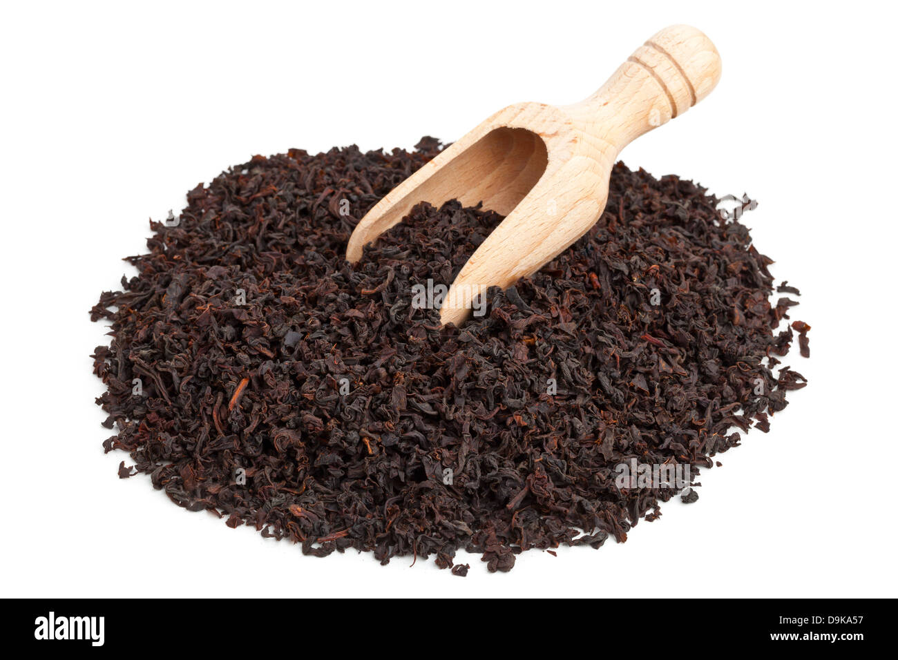 Ceylon black tea crop in wooden scoop over white background Stock Photo