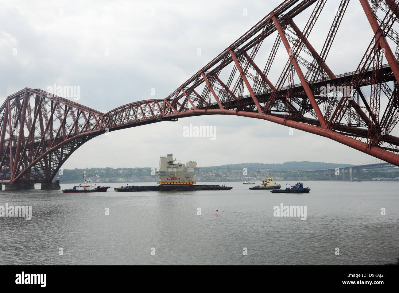 The Forth, near Edinburgh, UK. 21st June, 2013. Final piece of new aircraft carrier entering under the Forth Bridge near Rosyth. The section of aircraft carrier was built in Scotstoun and was being taken to the Rosyth dockyard Credit:  Linda Jones/Alamy Live News Stock Photo