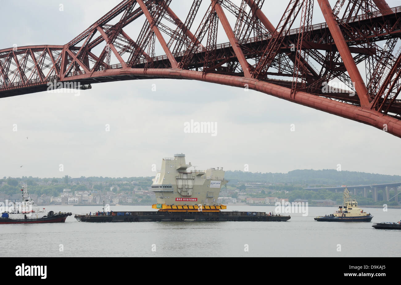 The Forth, near Edinburgh, UK. 21st June, 2013. Final piece of new aircraft carrier (HMS Queen Elizabeth) entering under the Forth Bridge near Rosyth. The section of aircraft carrier was built in Scotstoun and was being taken to the Rosyth dockyard Credit:  Linda Jones/Alamy Live News Stock Photo