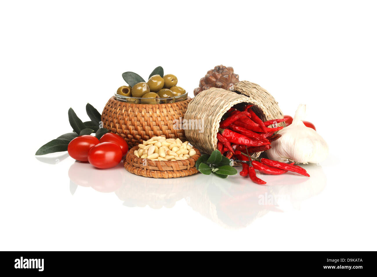 Olives, tomatoes, garlic, chilli and pine cores Stock Photo