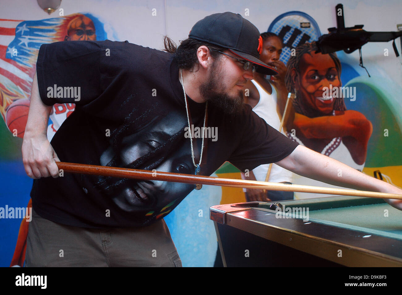 Young man playing pool at the Bar The Love Boat, Bob Marley T-shirt, Negril, Jamaica Stock Photo