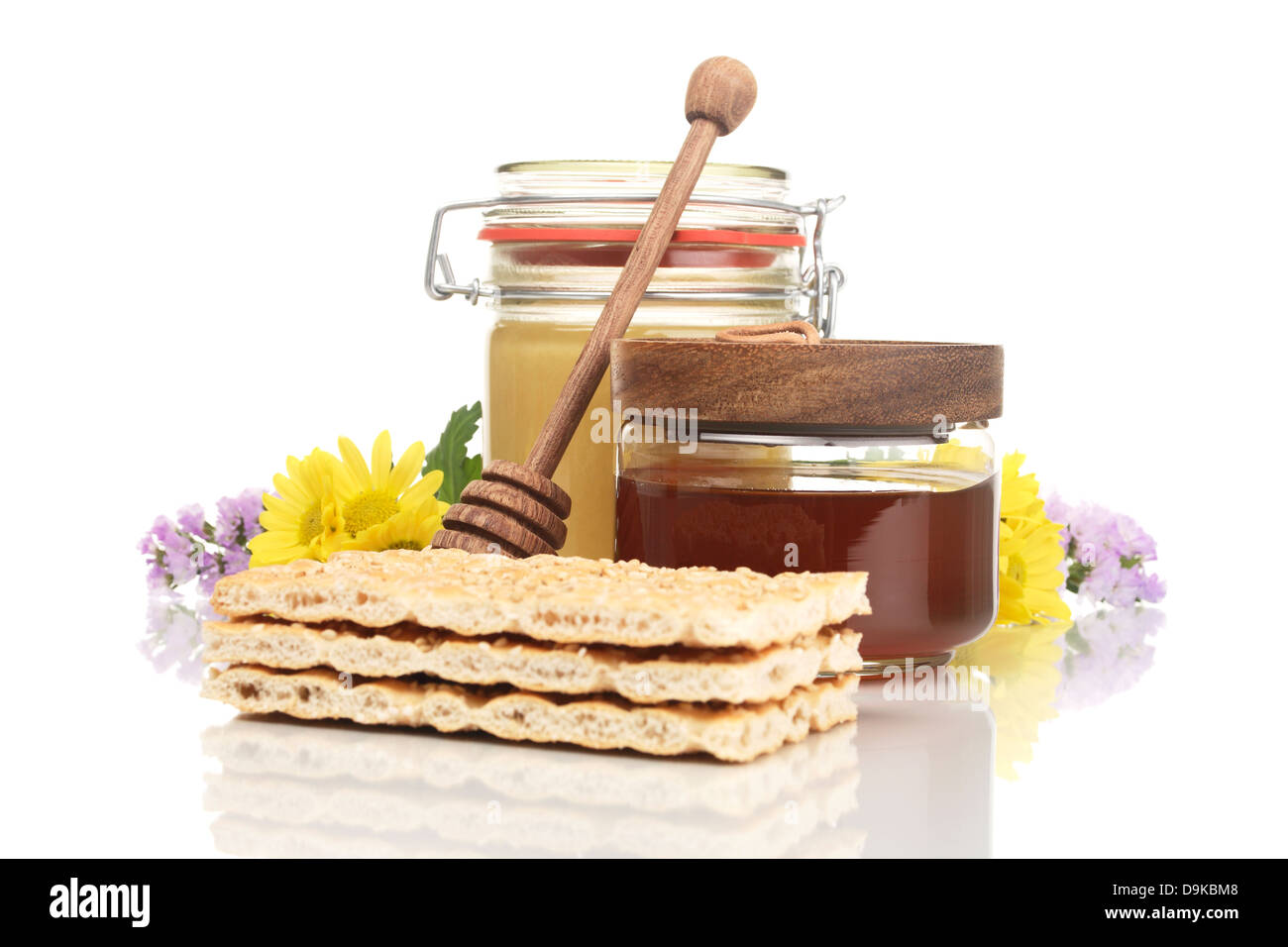 Honey glasses with crispbread and honey spoon, Crispbread with jars of honey and honey spoon Stock Photo