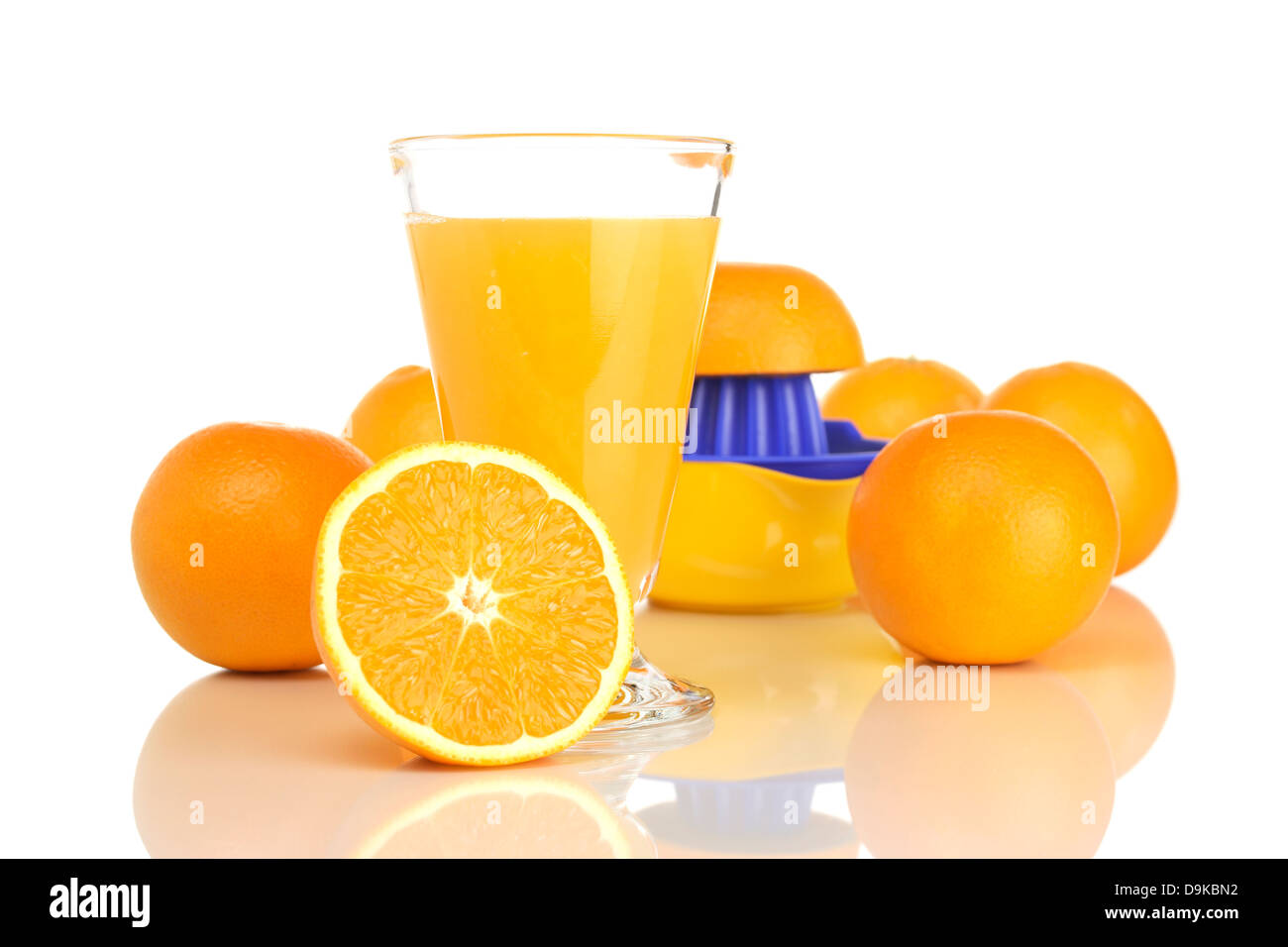 Glass with orange juice, oranges and juice extractor, Glass with orange
