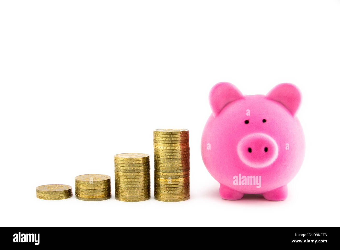 Pink piggy bank and coins Stock Photo - Alamy