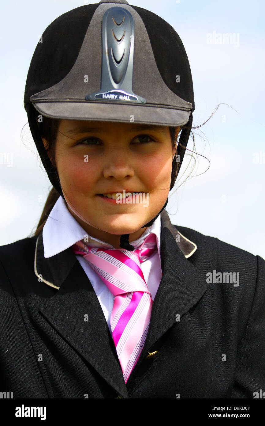 12 year old girl happily posing on her pony Stock Photo