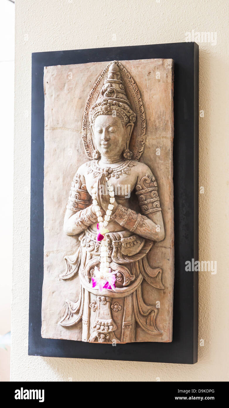Benign stone sculpture of angel decorated wall Stock Photo