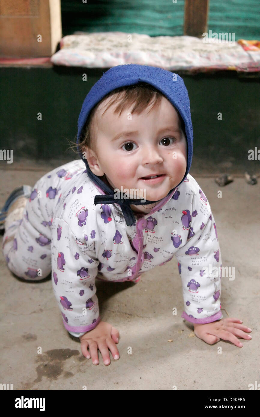 Tajik baby on the floor, Pamir plateau, Tajikistan, Central Asia Stock Photo