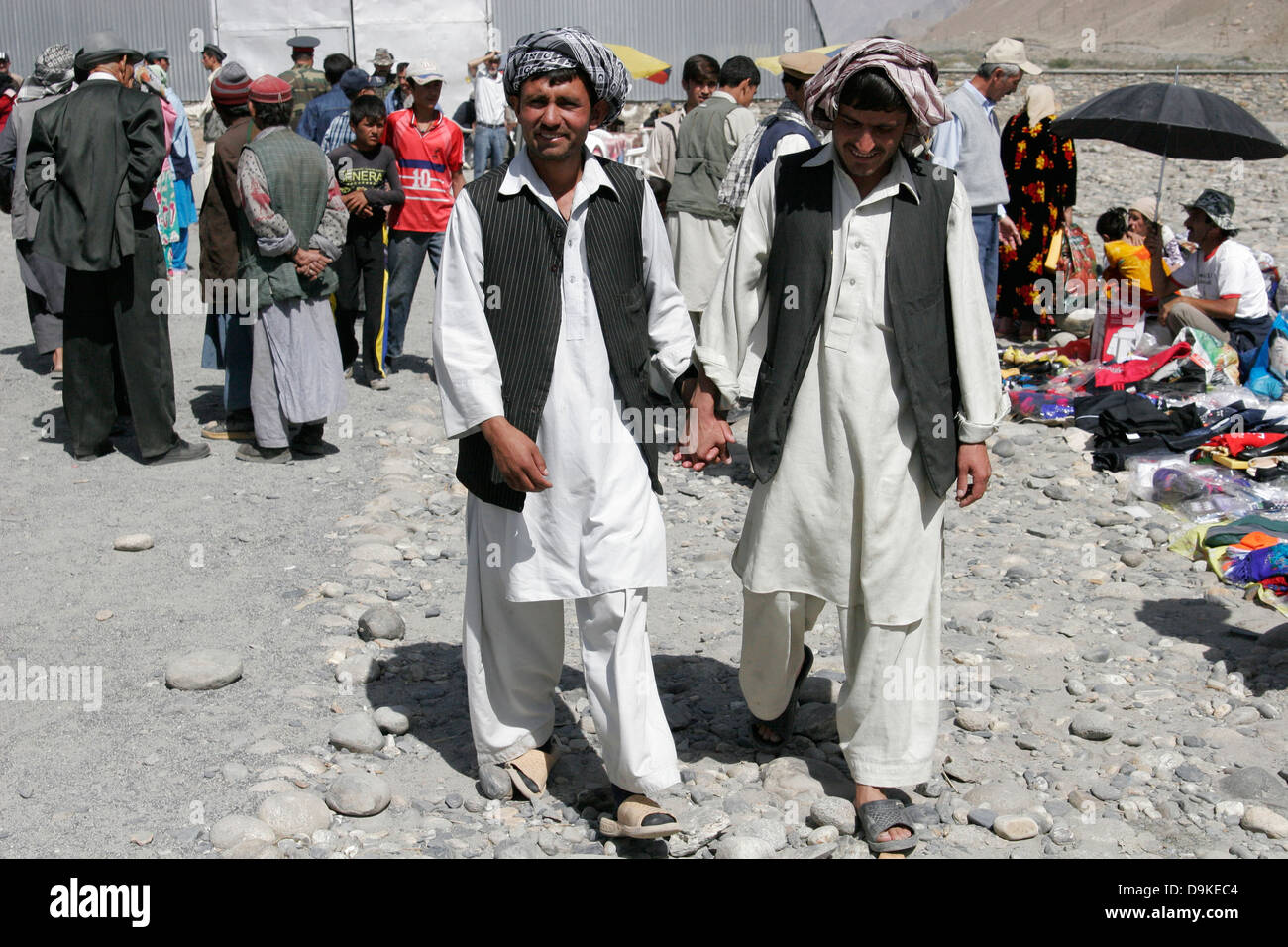 Afghan men wearing traditional clothes, transborder market near Ishkashim on the border between Tajikistan and Afghanistan Stock Photo