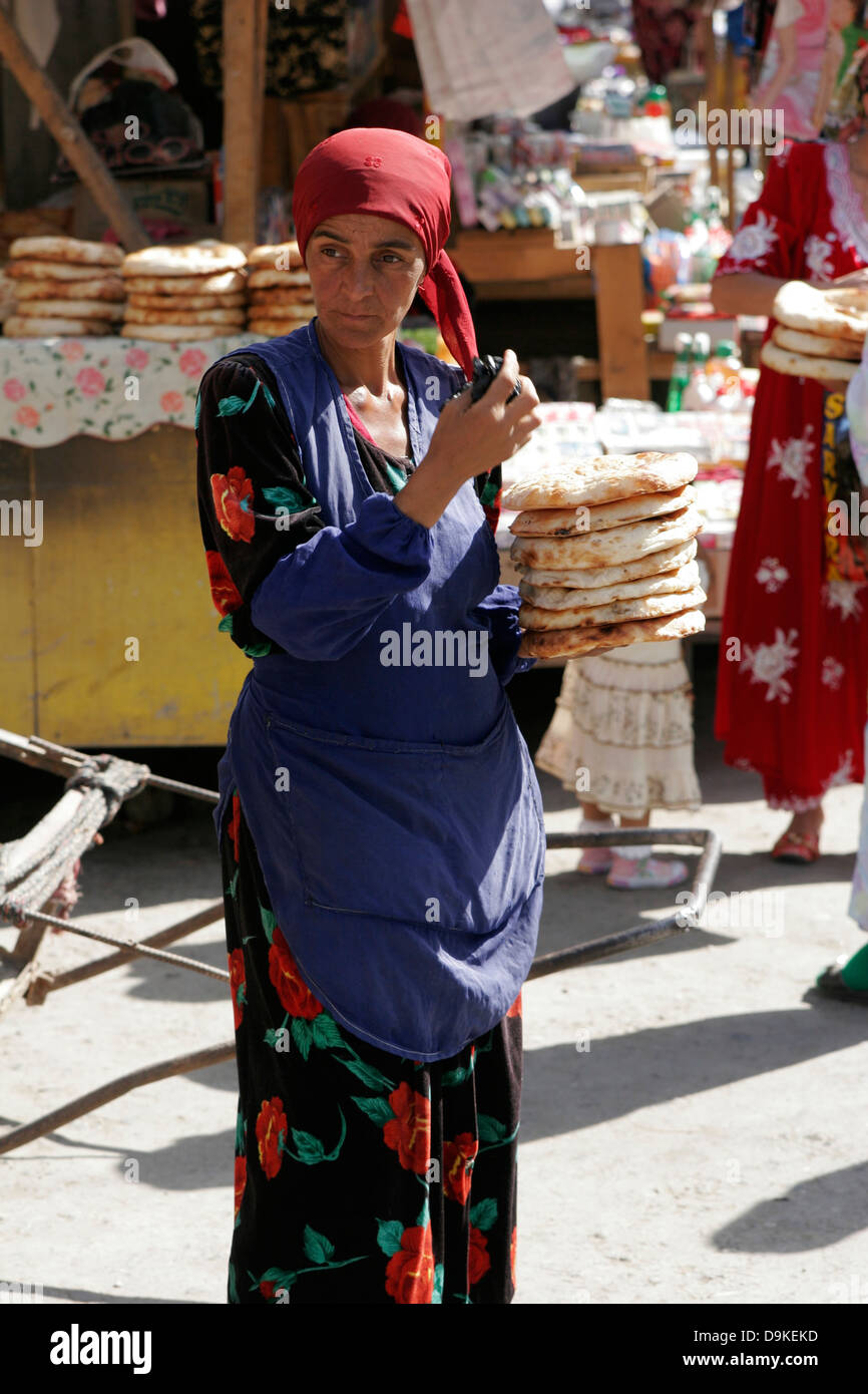 Tajik woman selling homemade bread at the market, Tajikistan Stock Photo