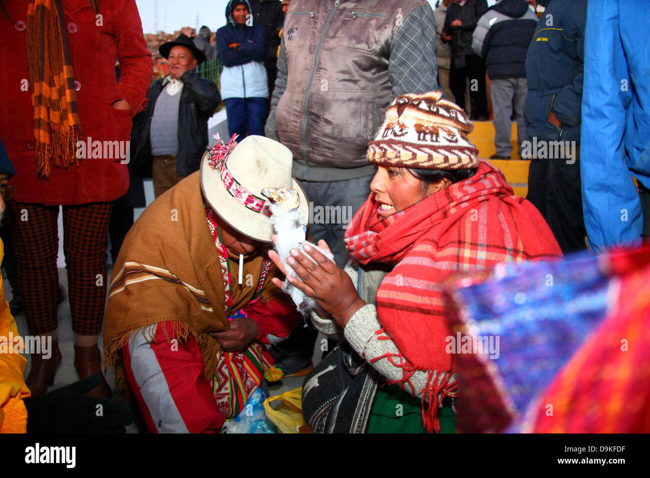 Magical Andes Photography  Aymara woman shopping at stall selling red and  yellow underwear on New Year's Eve, La Paz, Bolivia photograph
